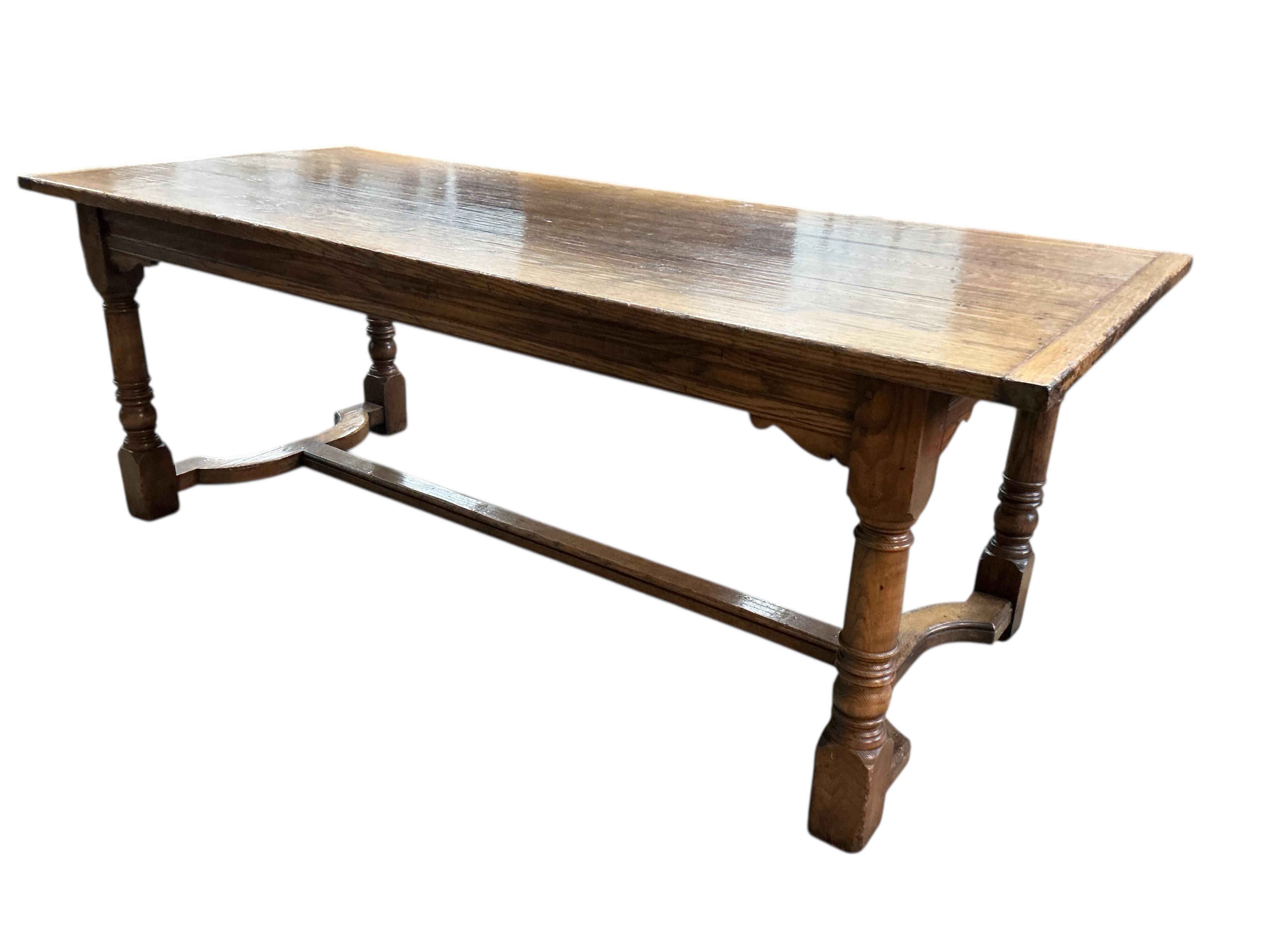 An 18th century style rectangular oak refectory dining table, width 214cm, depth 90cm, height 77cm together with six panelled oak high back dining chairs and two oak elbow chairs